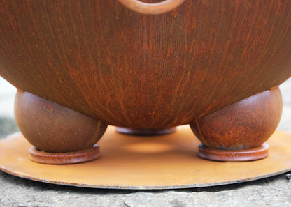 Hemispherical Feet by Fire Pit Art, shown fitted under a Nepal fire pit | Outdoor Heat Direct